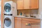 Between the kitchen and the garage is a laundry room with a washer and dryer.
